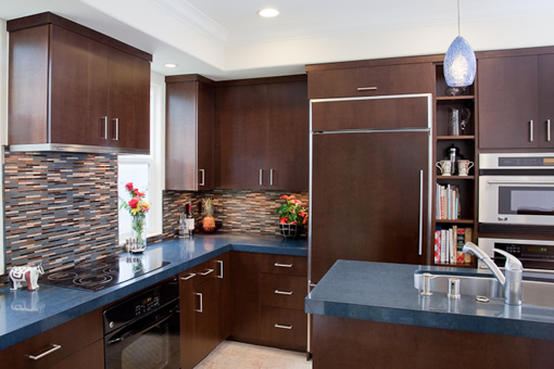 Kitchen Cabinets with Bookmatched Aires Doors Wood Panels on Refrigerator Sink in the Island Flat Crown Molding